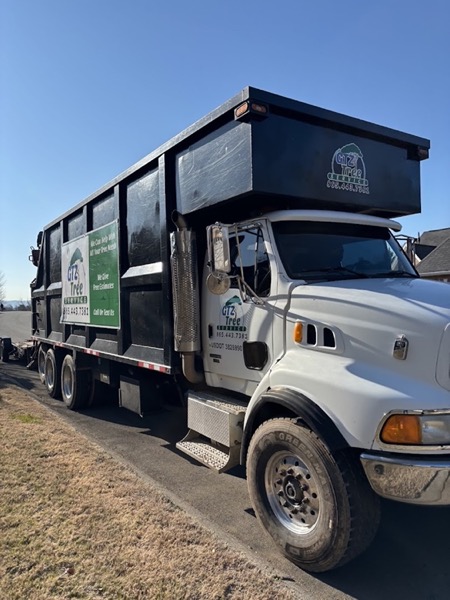 Black GTZ Tree Service dump truck at a worksite